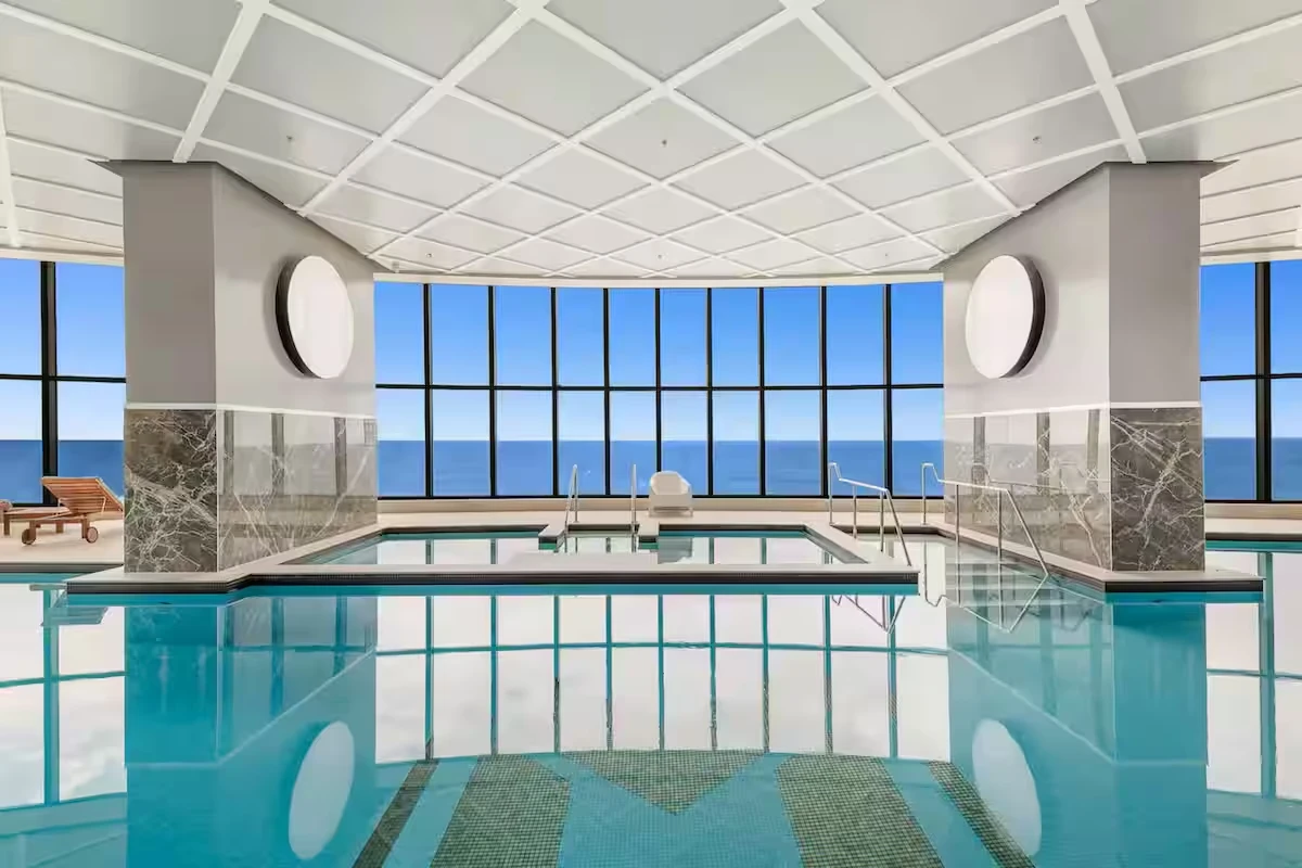 Indoor pool with floor-to-ceiling ocean windows